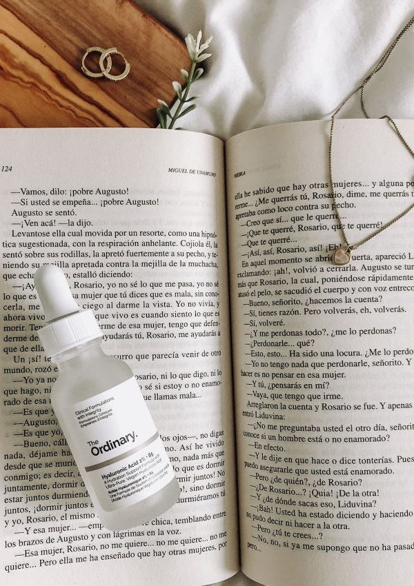 a book with The Ordinary hyaluronic acid on top